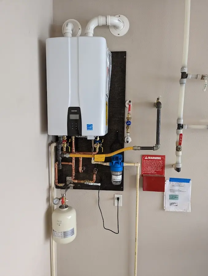 Professional plumber installing copper piping in a Ensley home